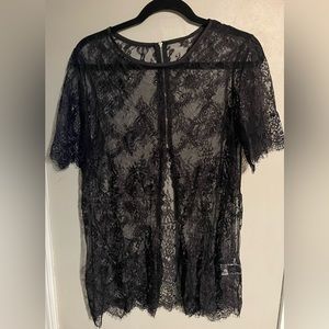 Women’s flower sheer black shirt with zipper in back.